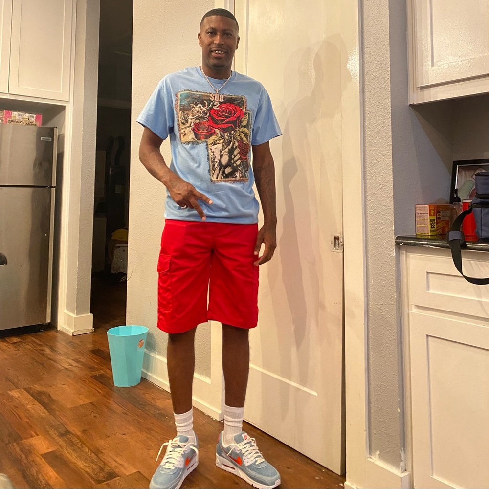 Nike shoes and red shorts and blue shirt